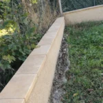 Création de muret maçonné avec enduit extérieur et pose de couvre-mur à Thoiry